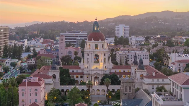 an aerial view of residential houses with city view