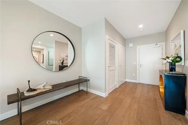 a living room with furniture a rug a fireplace and a large window