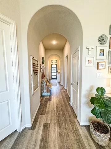 a view of a hallway view with wooden floor and staircase