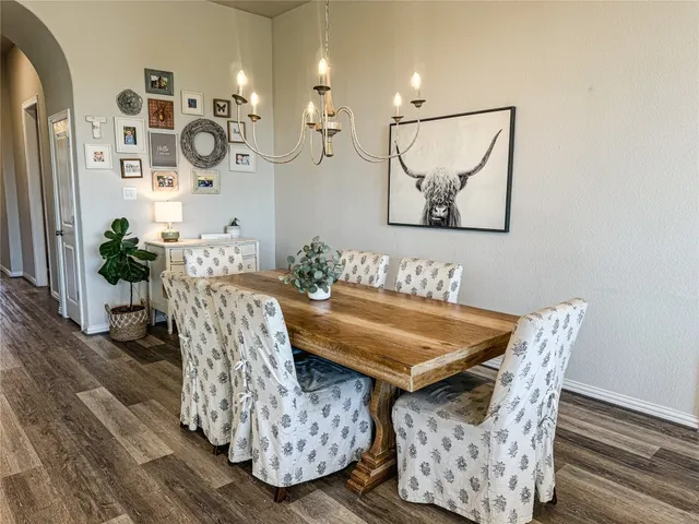 a dining room with furniture and wooden floor