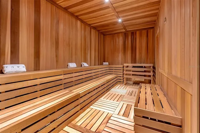 a bedroom with two beds and a painting on the wall