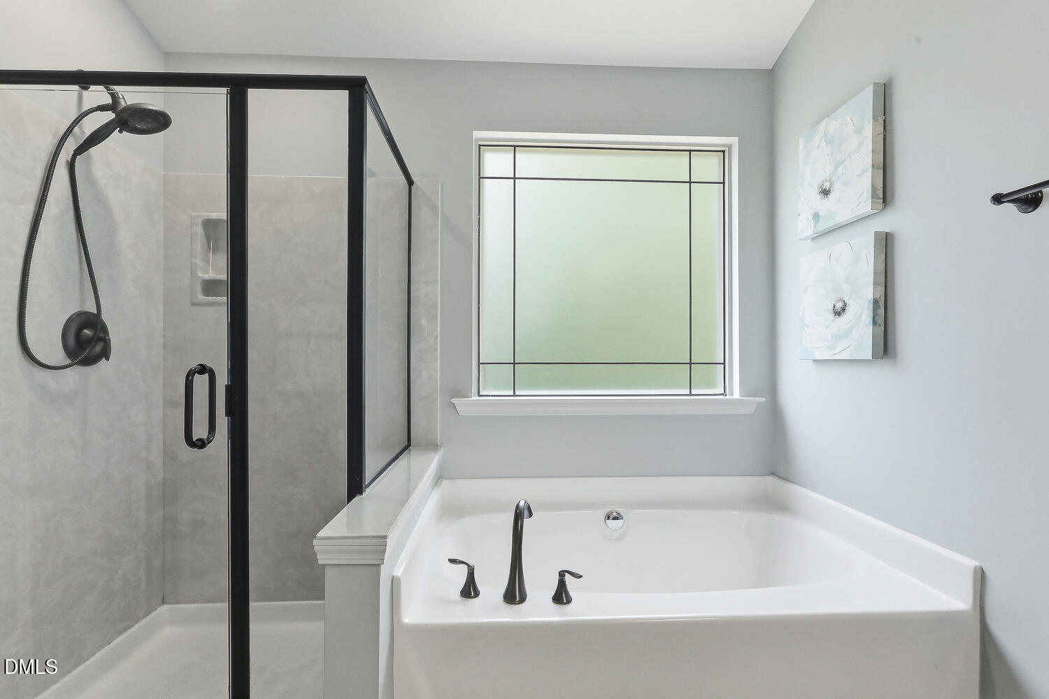 441 Virginia Water Drive Rolesville, NC 27571 - Photo 11 of 20 a bathroom with a bathtub a shower and a window