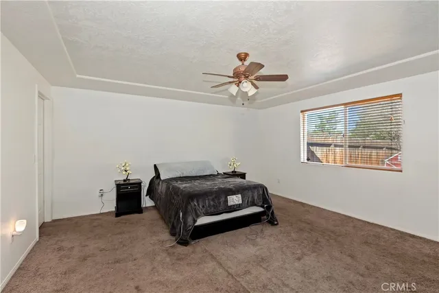 a room with a bed and a chandelier