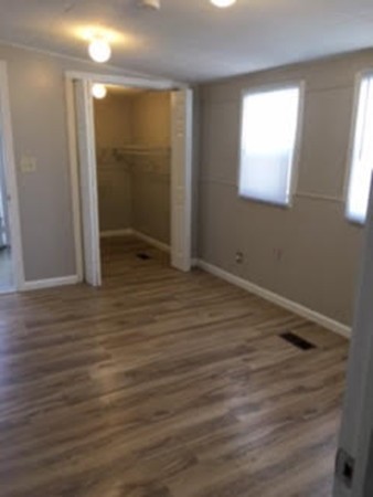 63 Better Way Springfield, MA 01119 - Photo 6 of 12 an empty room with wooden floor and windows