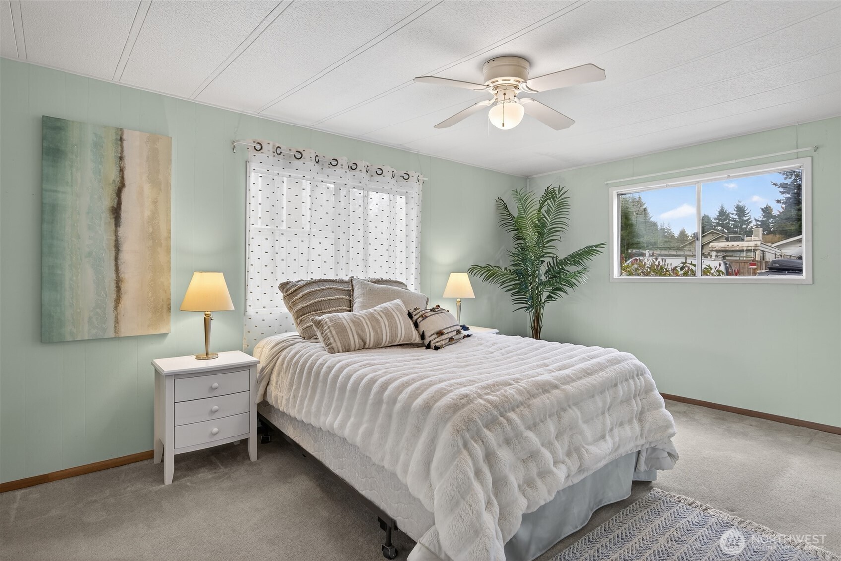 3323 207th Place Southeast Bothell, WA 98012 - Photo 12 of 33 a bedroom with a large bed and a chandelier