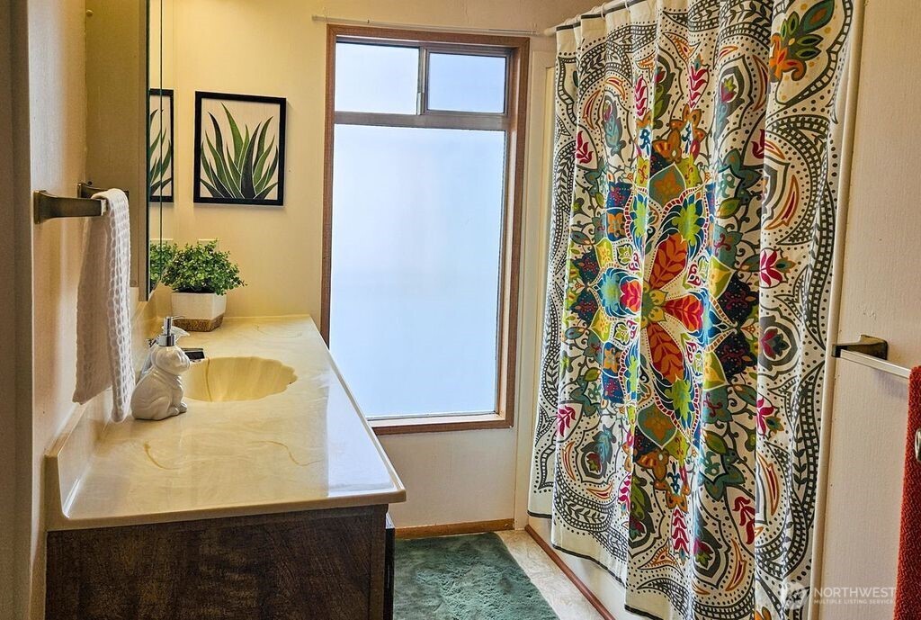 3323 207th Place Southeast Bothell, WA 98012 - Photo 24 of 33 a bathroom with a sink and mirror with bathtub