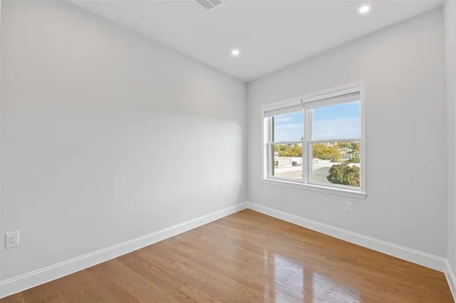 a view of an empty room and wooden floor