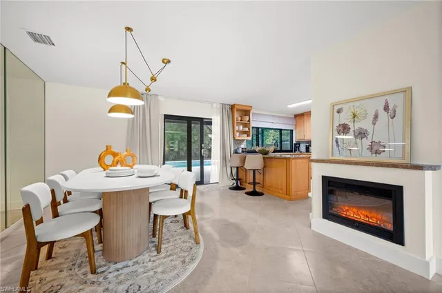 a living room with furniture a fireplace and a table