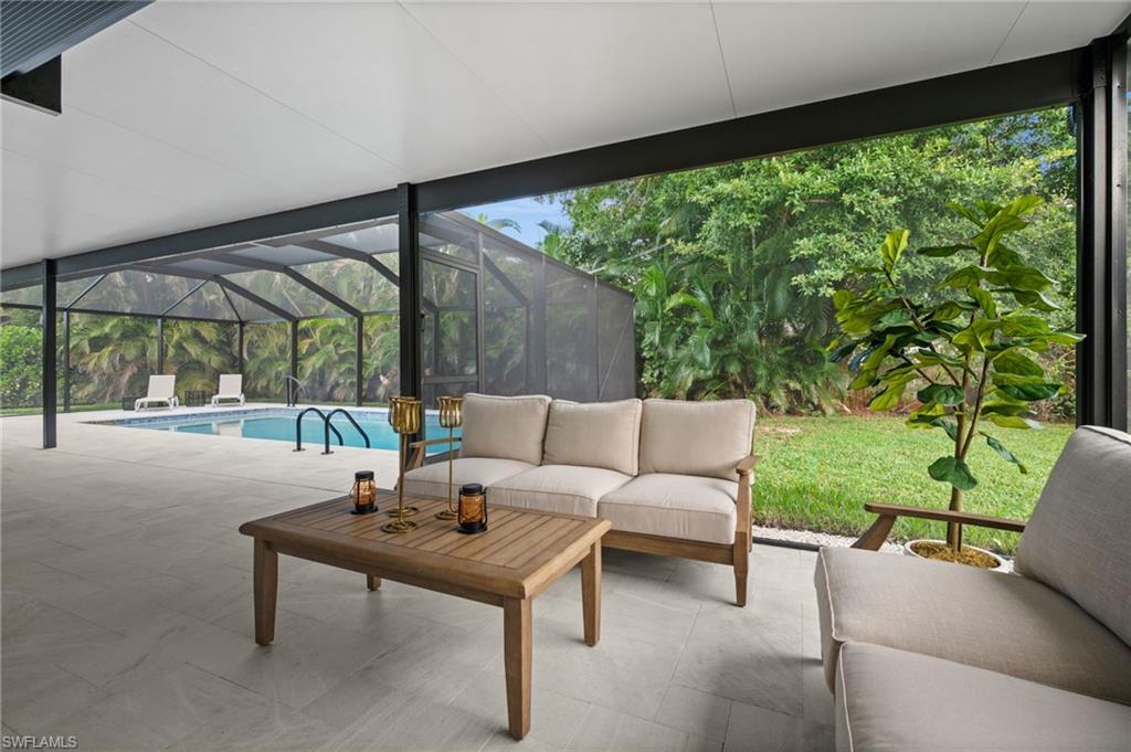 472 Palm River Boulevard Naples, FL 34110 - Photo 11 of 50 a outdoor living space with furniture and garden view