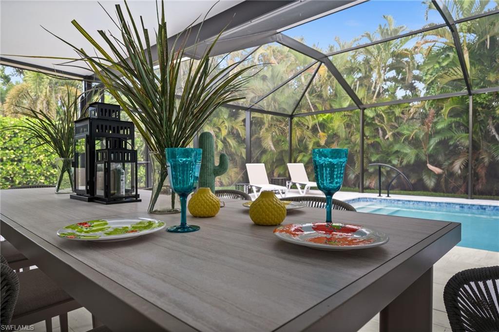 472 Palm River Boulevard Naples, FL 34110 - Photo 12 of 50 a view of a table and chairs in patio