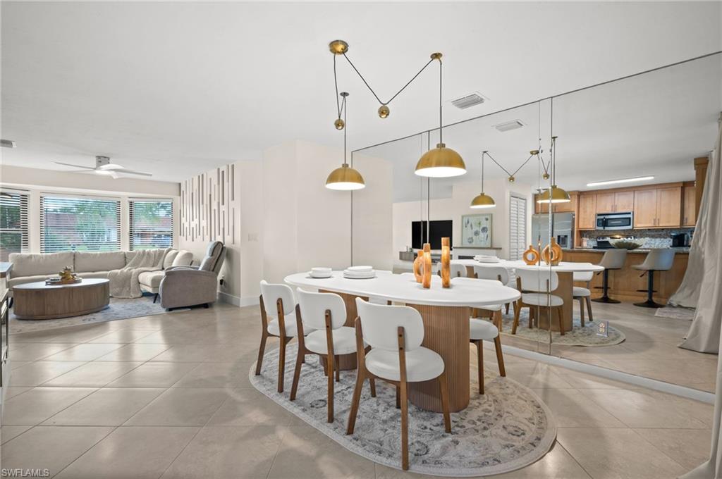 472 Palm River Boulevard Naples, FL 34110 - Photo 16 of 50 a living room with lots of furniture and a chandelier