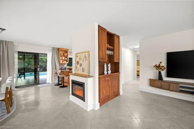 a view of living room filled with furniture and large window