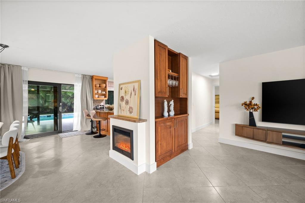 472 Palm River Boulevard Naples, FL 34110 - Photo 20 of 50 a view of living room filled with furniture and large window