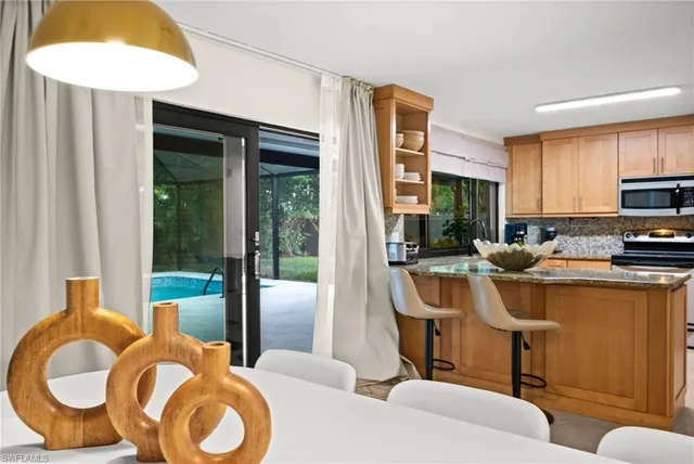 a kitchen with a refrigerator and a sink
