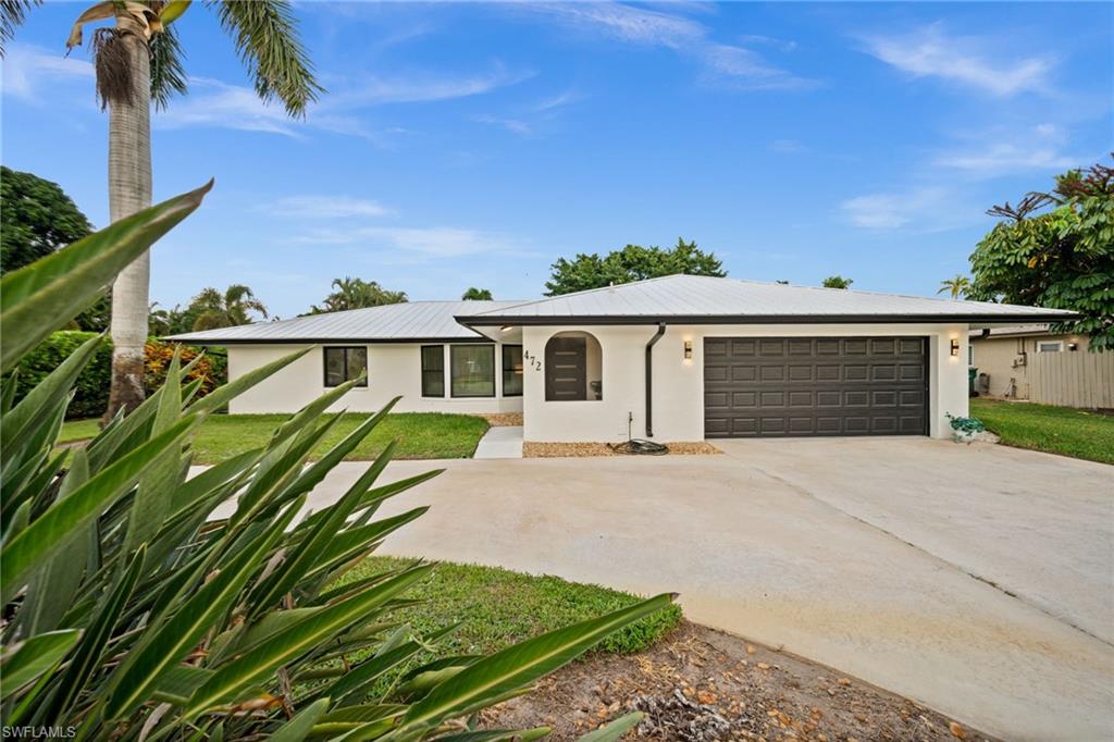 472 Palm River Boulevard Naples, FL 34110 - Photo 22 of 50 front view of a house with a yard