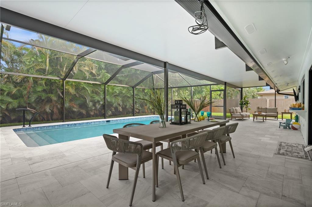472 Palm River Boulevard Naples, FL 34110 - Photo 23 of 50 a view of an outdoor dining space with a table and chairs