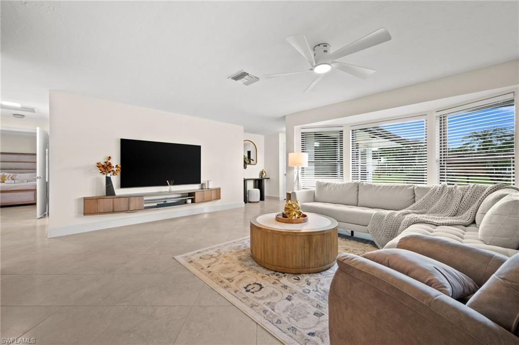 472 Palm River Boulevard Naples, FL 34110 - Photo 29 of 50 a living room with furniture and a flat screen tv