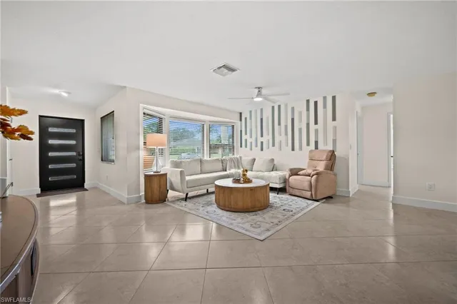 a living room with furniture and large window