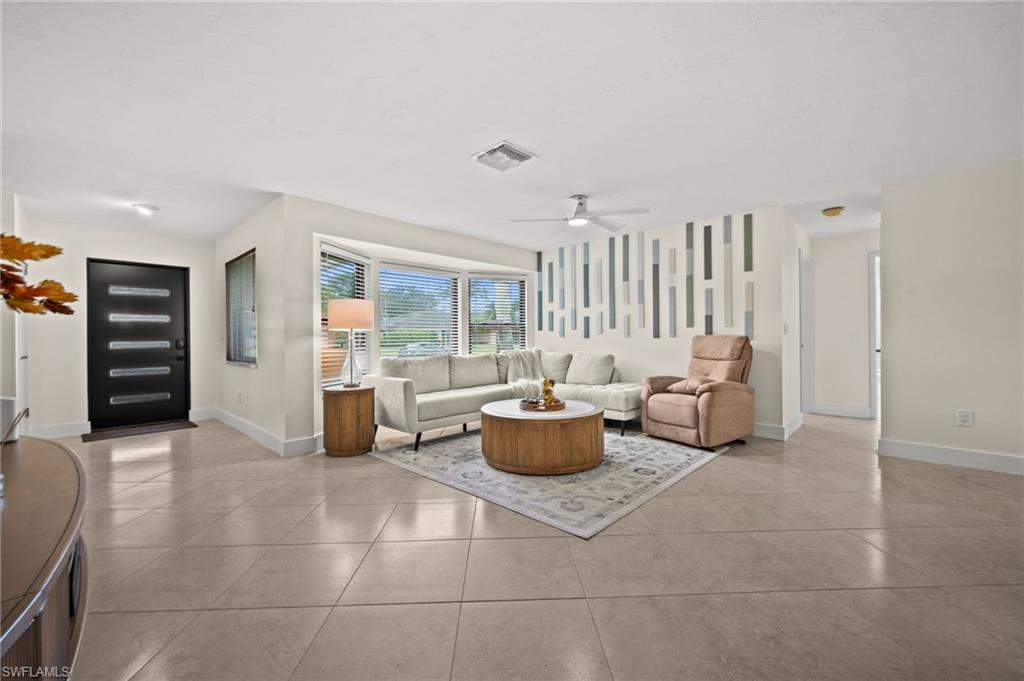 472 Palm River Boulevard Naples, FL 34110 - Photo 30 of 50 a living room with furniture and large window