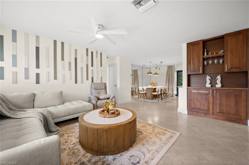 472 Palm River Boulevard Naples, FL 34110 - Photo 31 of 50 a living room with furniture and a table