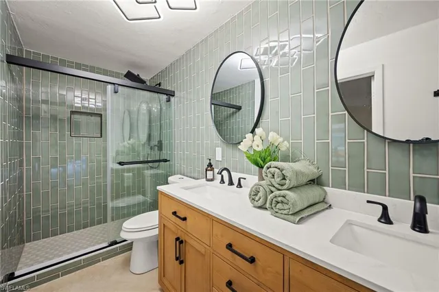 a bathroom with a sink mirror and toilet