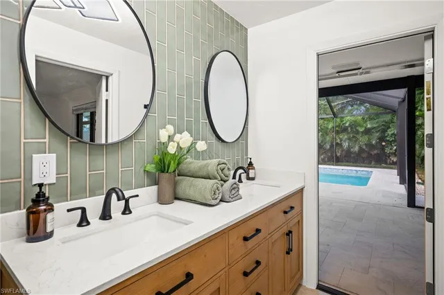 a bathroom with a double vanity sink and a mirror