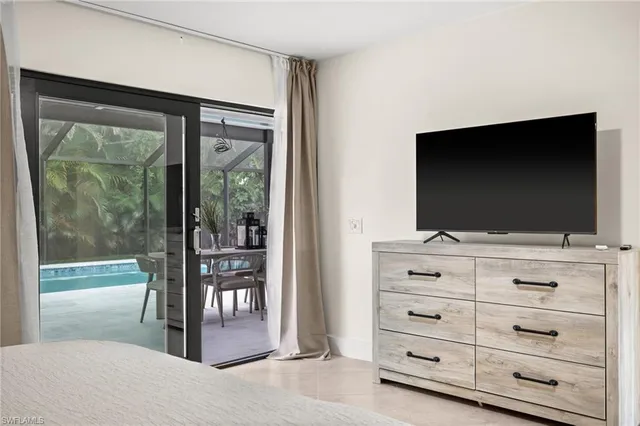 a view of room with window and flat screen tv