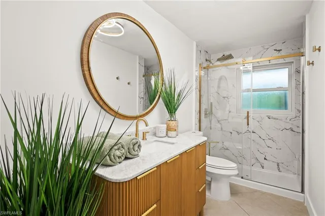 a bathroom with a sink mirror and toilet