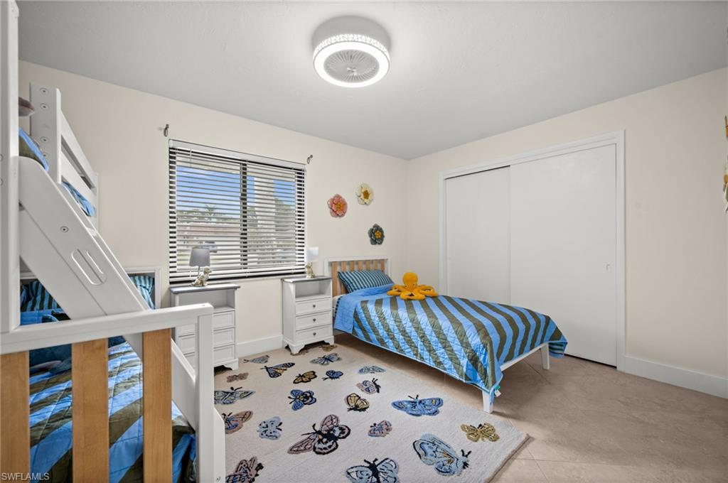 472 Palm River Boulevard Naples, FL 34110 - Photo 42 of 50 a bedroom with furniture and a window