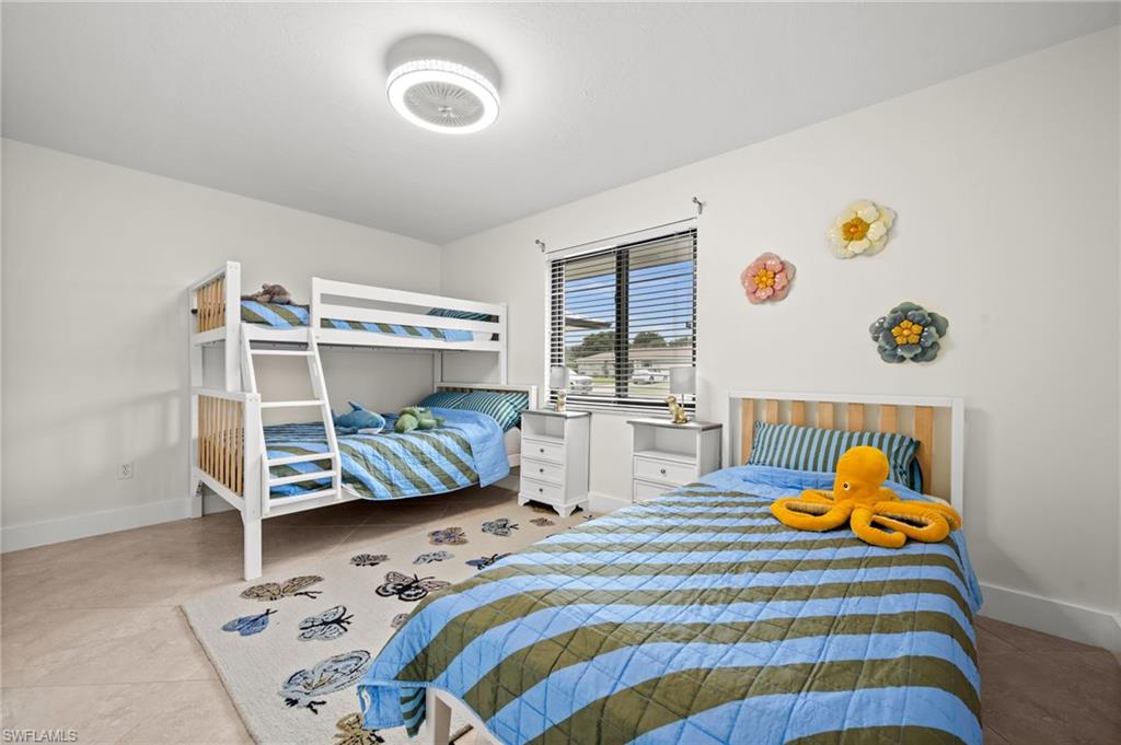 472 Palm River Boulevard Naples, FL 34110 - Photo 44 of 50 a bedroom with a bed and a window