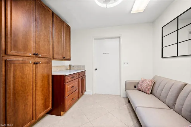 a living room with a bed furniture and a window
