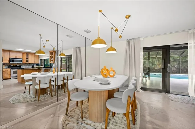 a dining room filled with furniture and a chandelier