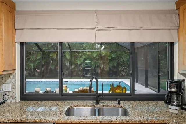 a kitchen with a sink and a large window