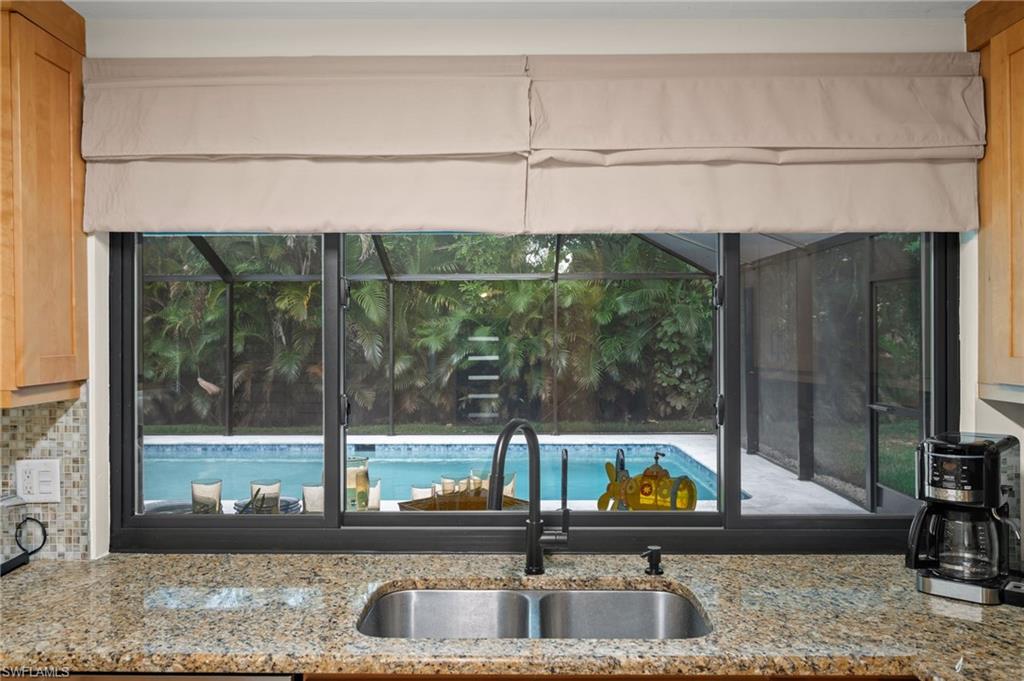 472 Palm River Boulevard Naples, FL 34110 - Photo 9 of 50 a kitchen with a sink and a large window