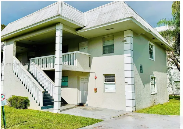 a view of swimming pool with a garden and trees