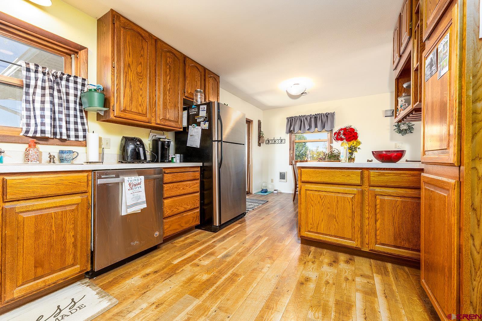 9467 6097 Road Montrose, CO 81401 - Photo 12 of 34 a kitchen with stainless steel appliances granite countertop a sink and cabinets