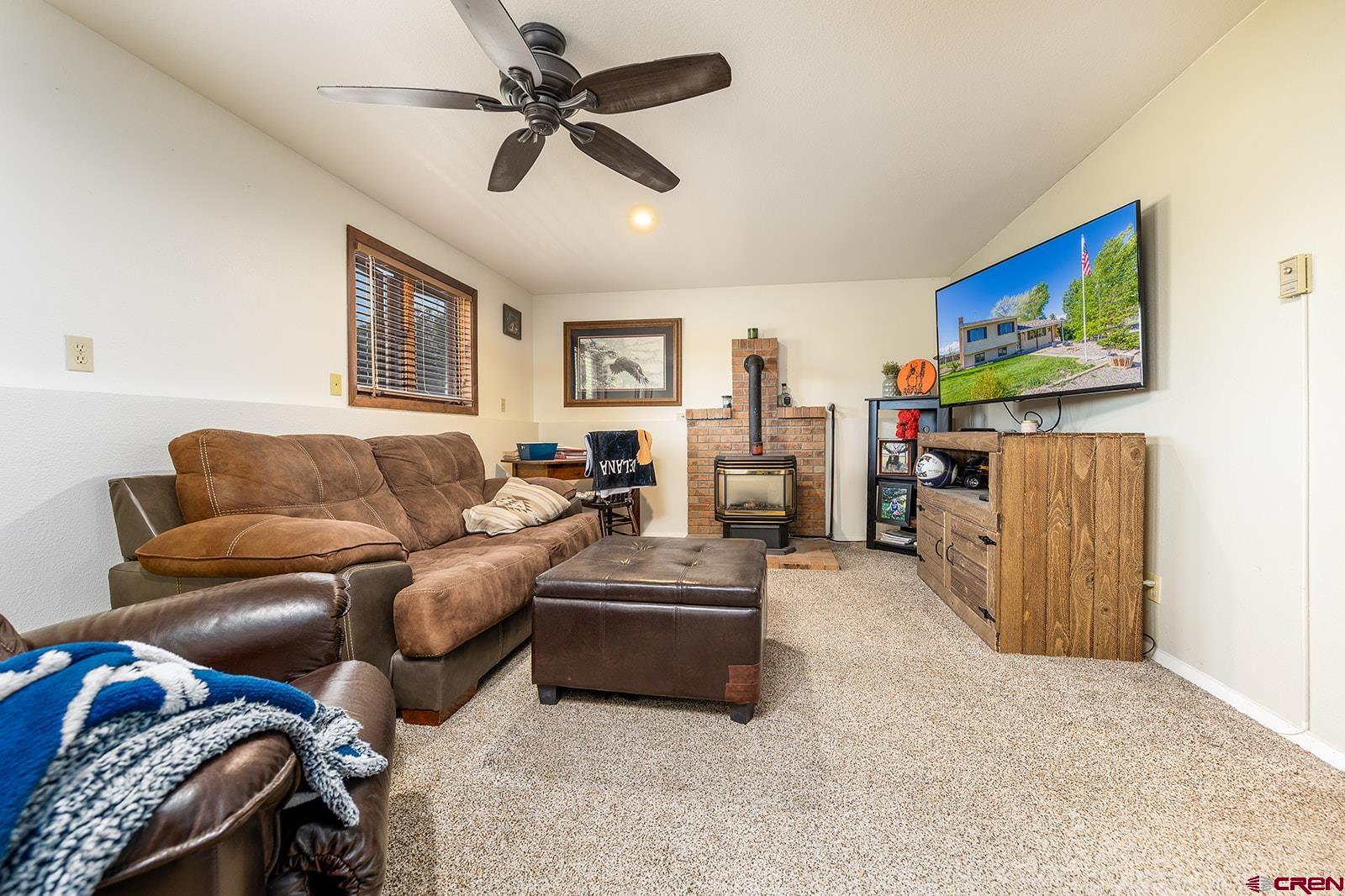 9467 6097 Road Montrose, CO 81401 - Photo 13 of 34 a living room with furniture and a flat screen tv