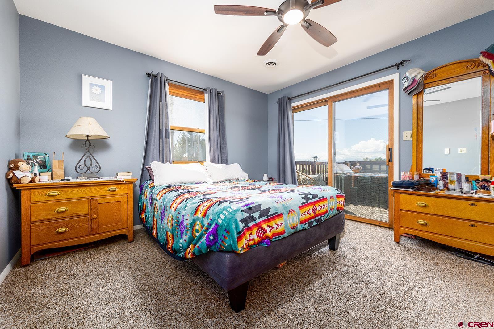 9467 6097 Road Montrose, CO 81401 - Photo 16 of 34 a room with a bed and a ceiling fan