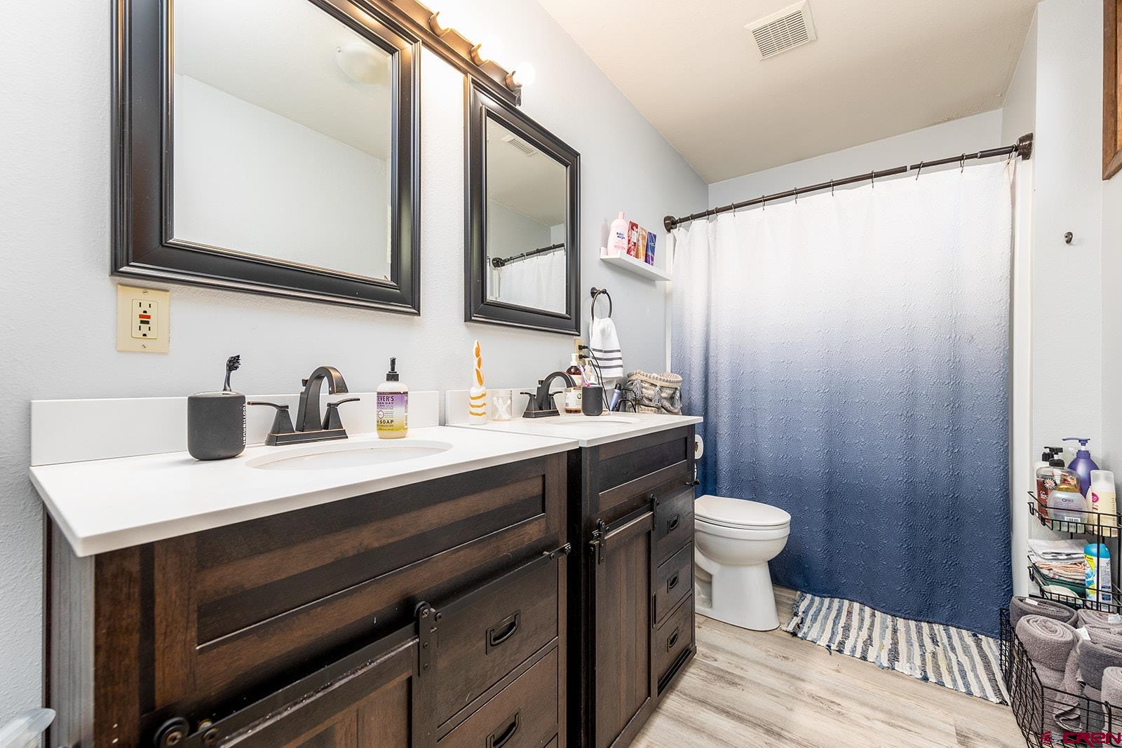 9467 6097 Road Montrose, CO 81401 - Photo 18 of 34 a bathroom with a sink a toilet and mirror