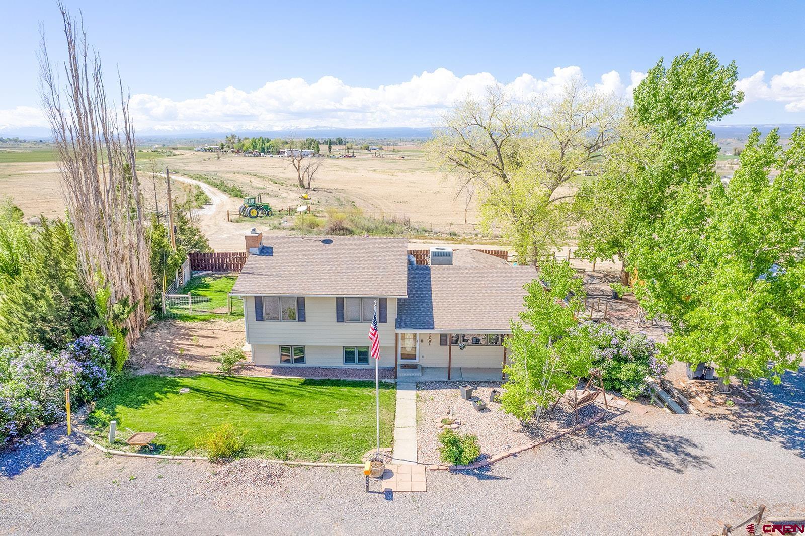 9467 6097 Road Montrose, CO 81401 - Photo 2 of 34 front view of a house with a yard