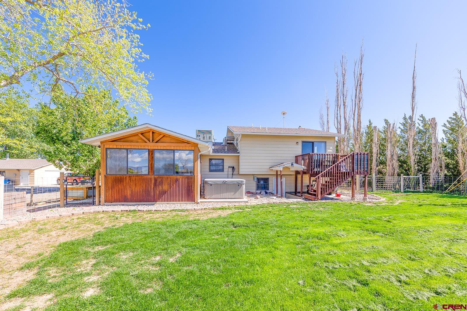 9467 6097 Road Montrose, CO 81401 - Photo 25 of 34 a view of a house with a yard and sitting area