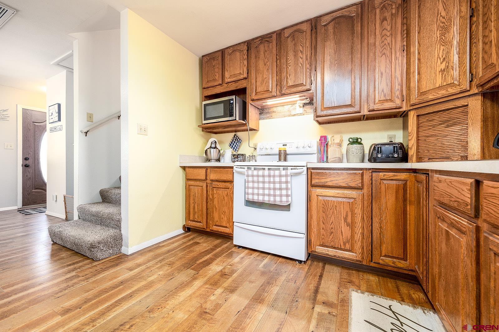 9467 6097 Road Montrose, CO 81401 - Photo 8 of 34 a kitchen with stainless steel appliances granite countertop a refrigerator a stove and a sink with cabinets