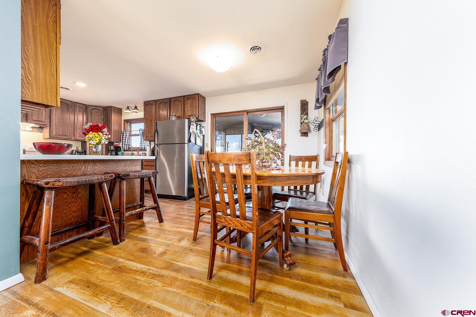 9467 6097 Road Montrose, CO 81401 - Photo 9 of 34 a dining area with furniture and wooden floor