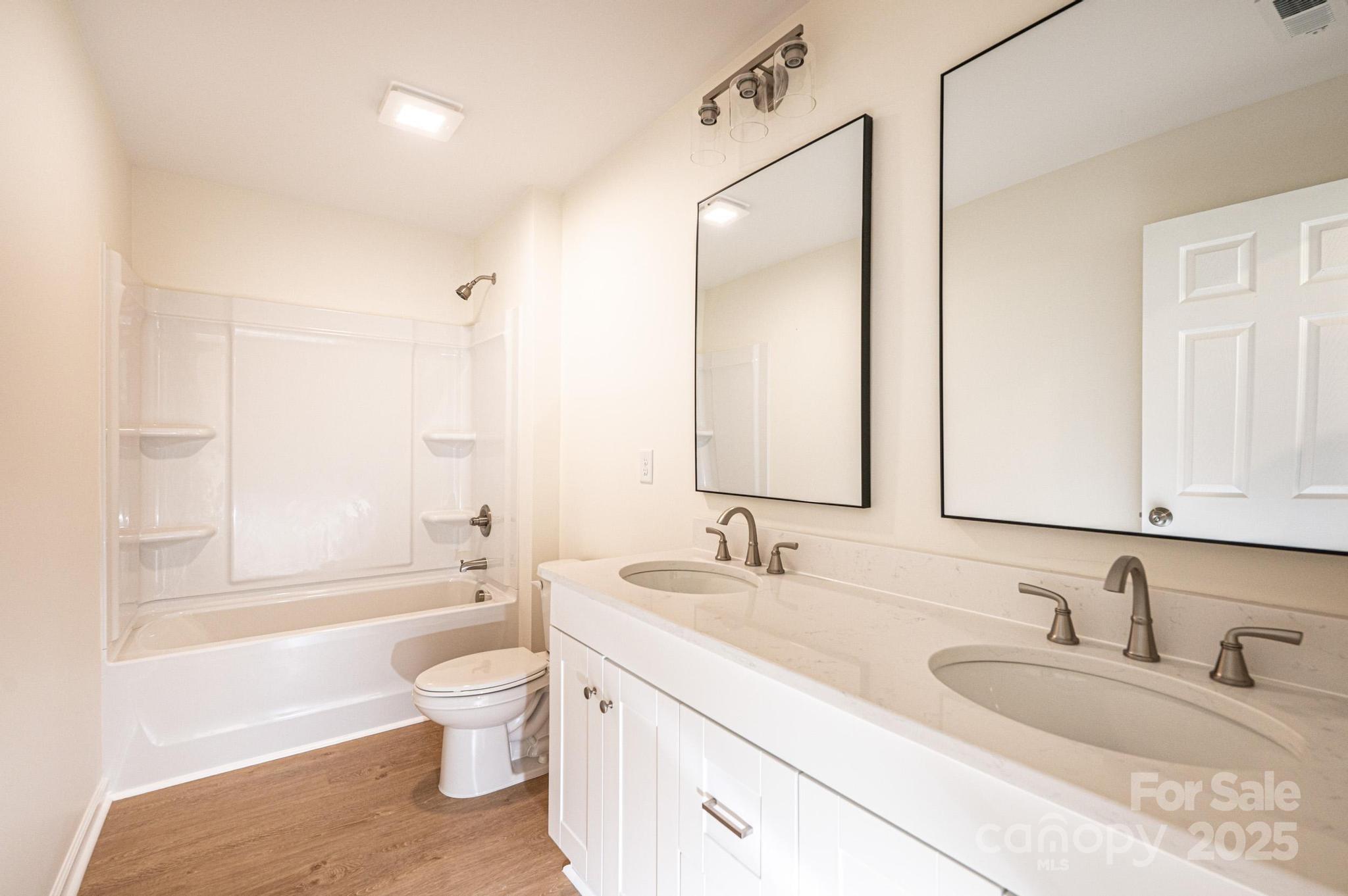 1449 4th Street Southwest Hickory, NC 28602 - Photo 14 of 19 a bathroom with a granite countertop toilet a sink and a bathtub
