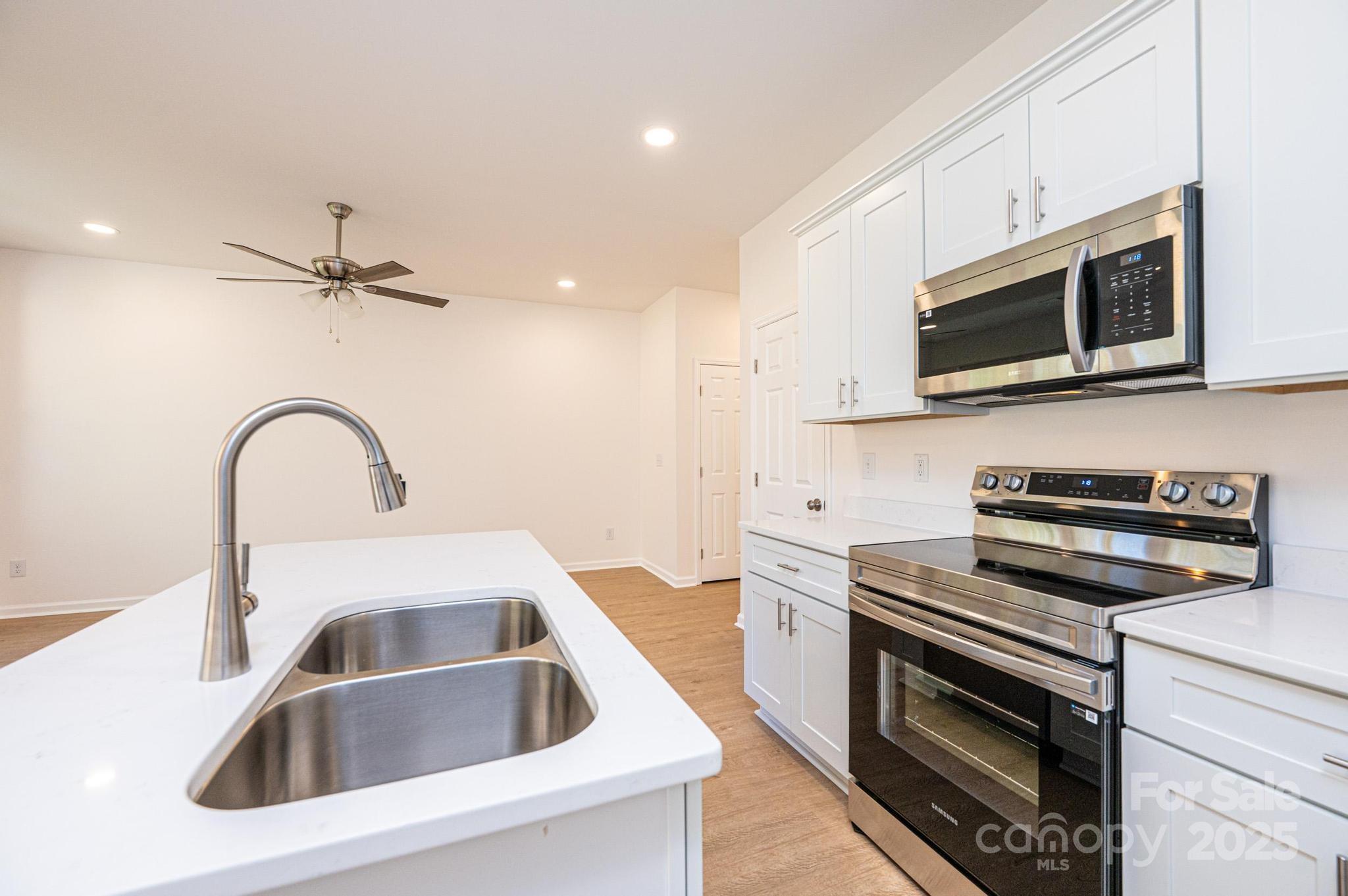 1449 4th Street Southwest Hickory, NC 28602 - Photo 5 of 19 a kitchen with a sink cabinets and stainless steel appliances
