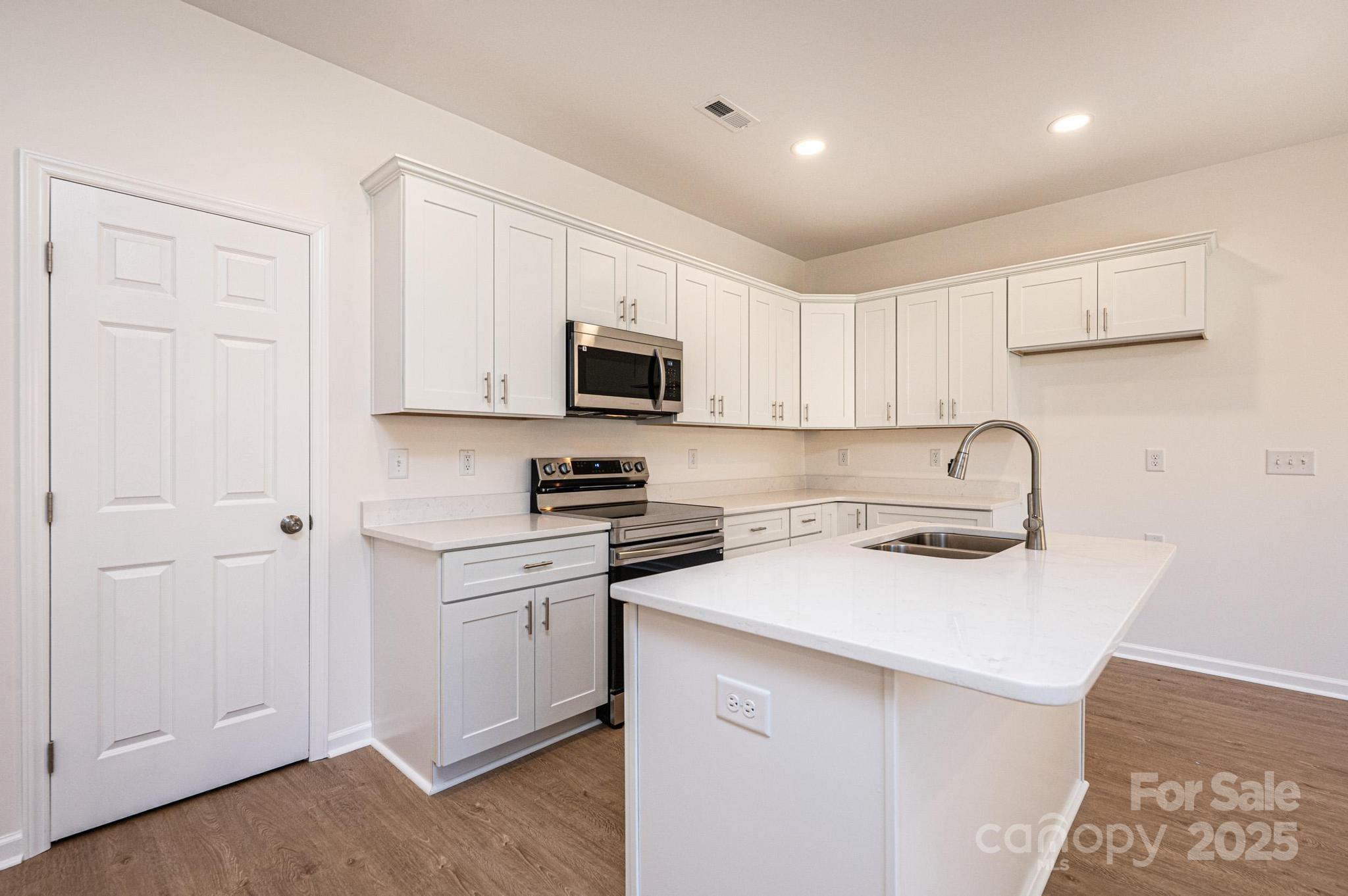 1449 4th Street Southwest Hickory, NC 28602 - Photo 6 of 19 a kitchen with cabinets appliances a sink and a counter top space
