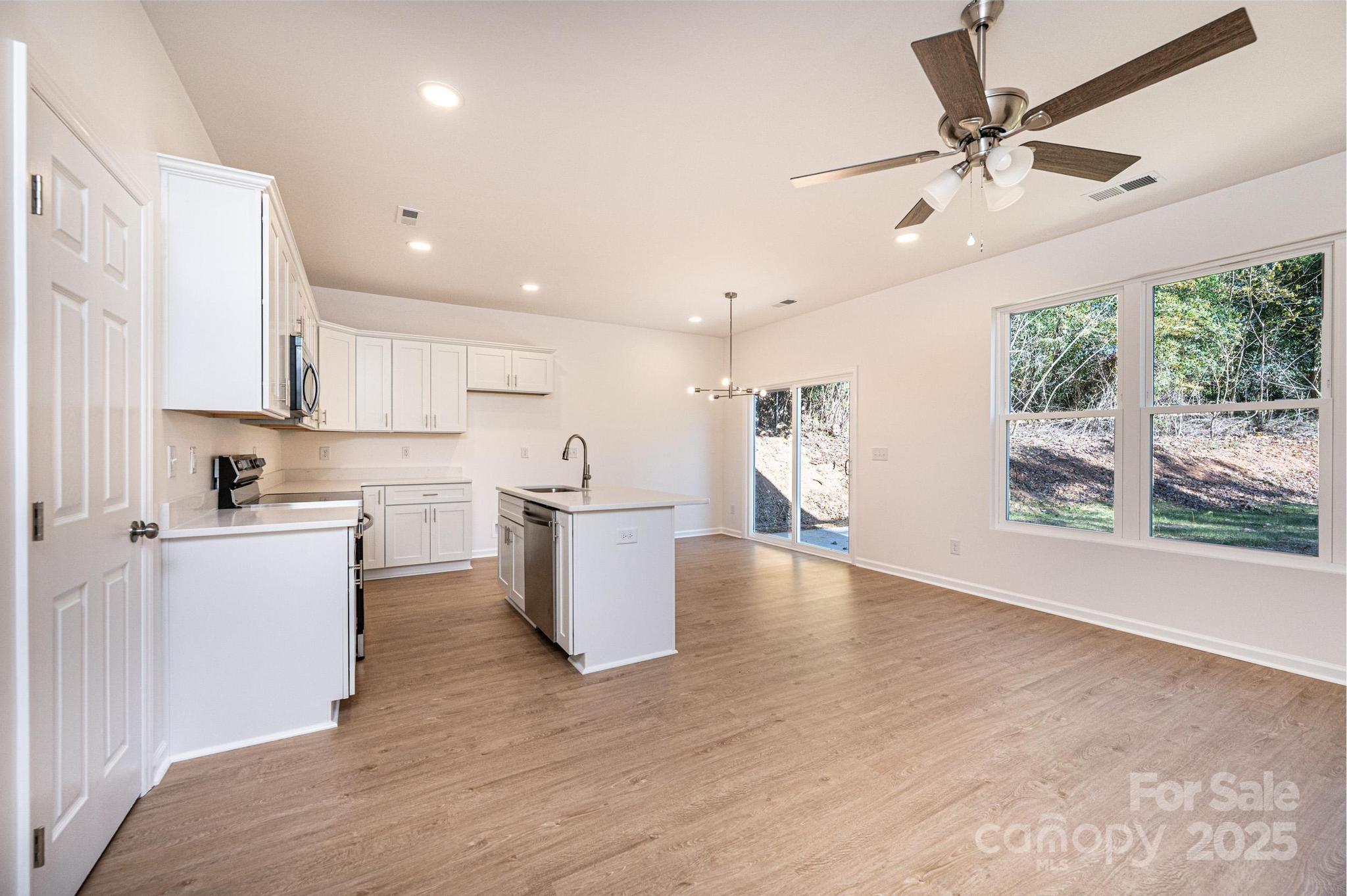 1449 4th Street Southwest Hickory, NC 28602 - Photo 9 of 19 a open kitchen with white cabinets and white appliances