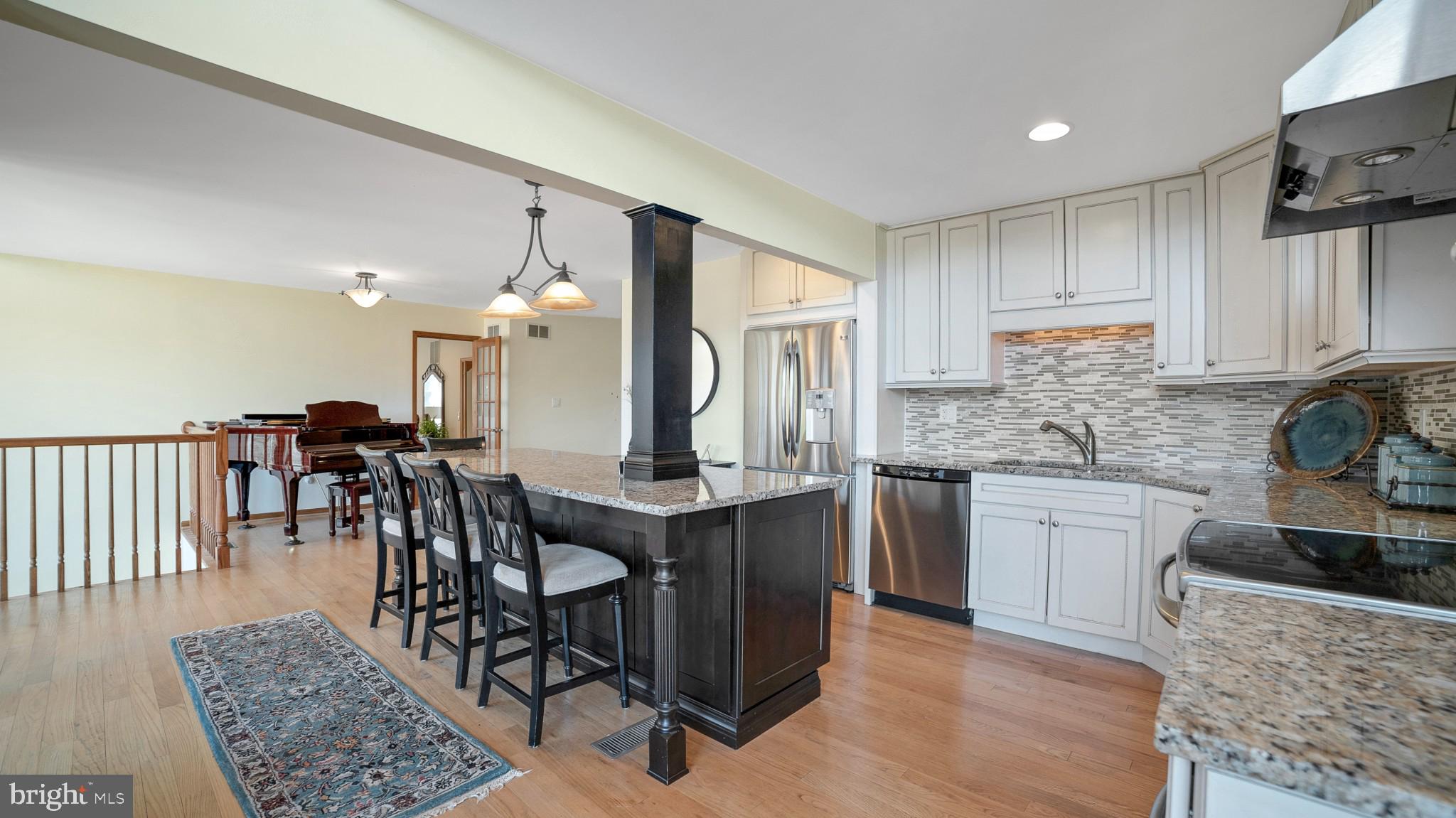 4757 Buffalo Road Mount Airy, MD 21771 - Photo 8 of 50 a kitchen with stainless steel appliances granite countertop dining table chairs sink and cabinets