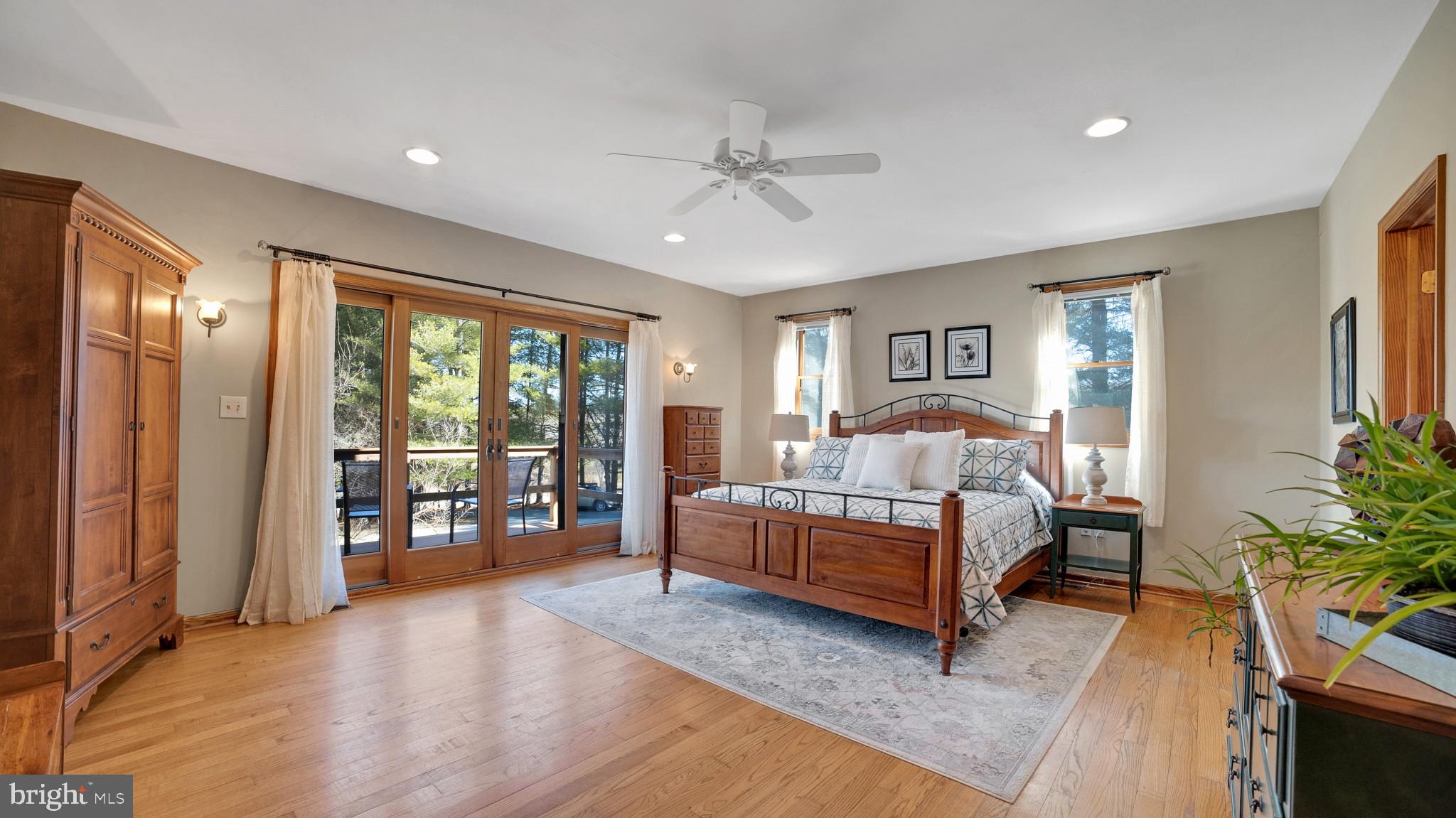 4757 Buffalo Road Mount Airy, MD 21771 - Photo 10 of 50 a spacious bedroom with a large bed and a chandelier