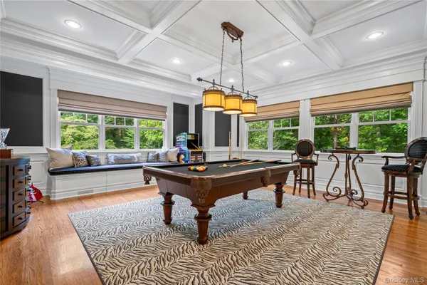 a living room with furniture a large window and a table